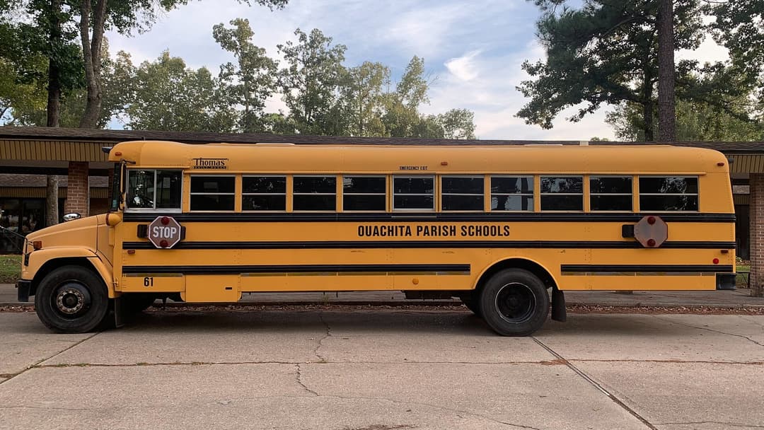 Yellow American school bus parked on a quiet residential street