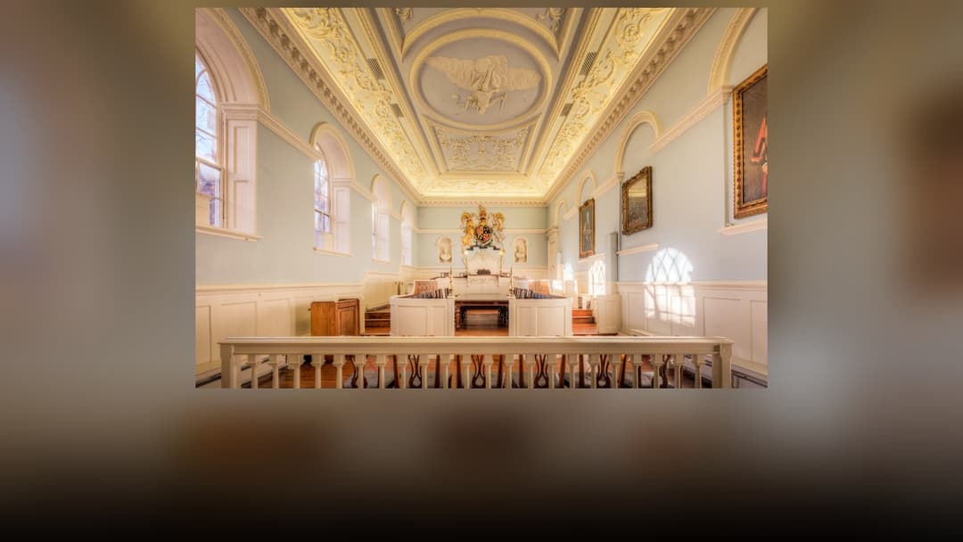Historic courtroom interior with witness stand and judicial bench.
