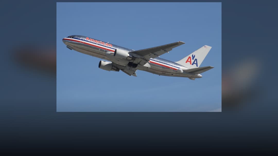 American Airlines Boeing 767 in classic bare polished metal livery with red, white, and blue cheatline.