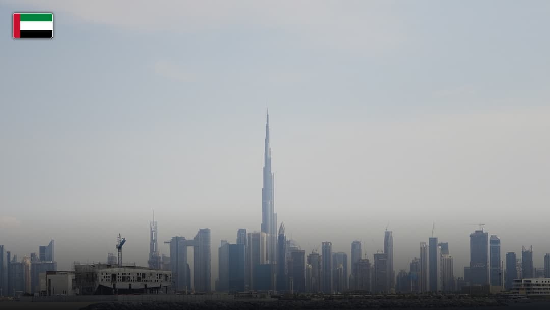 The Burj Khalifa piercing the Dubai skyline, with the flag of the United Arab Emirates.