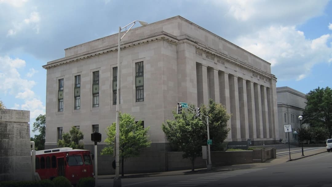 Neoclassical stone facade and grand colonnade of the Tennessee Supreme Court building in Nashville.