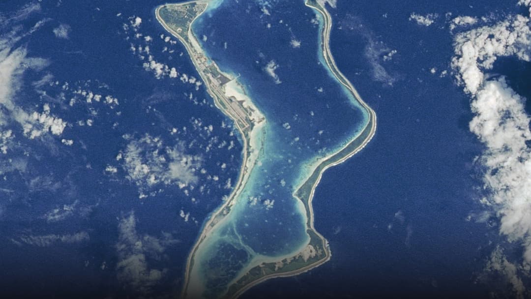 Aerial astronaut photograph showing the pristine coral atoll ring and turquoise lagoon of Diego Garcia.
