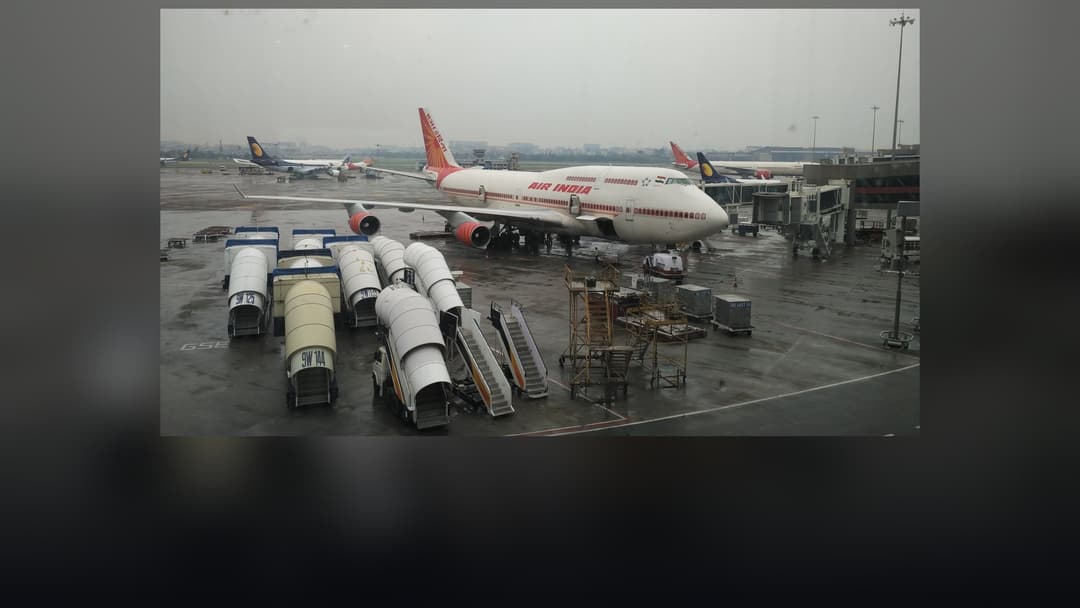 Air India Boeing 747 jumbo jet in service with distinctive crimson Rajasthani palace-window livery.