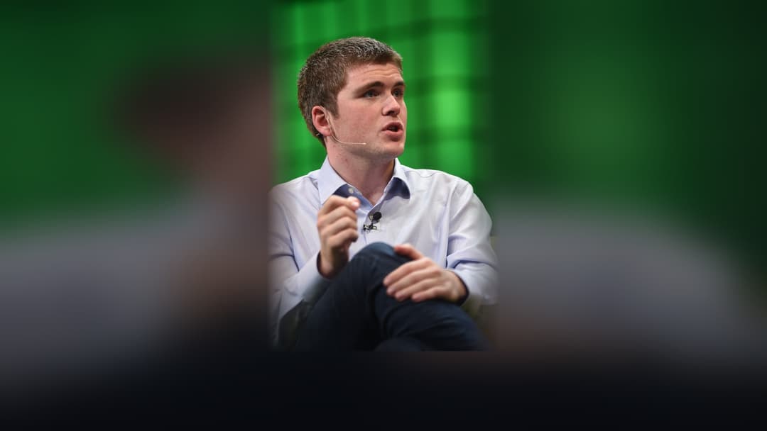 John Collison speaking during a technology panel at Web Summit.
