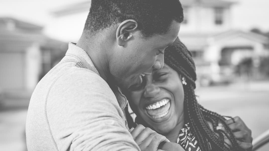 Happy couple smiling together showing similar facial proportions and expressions