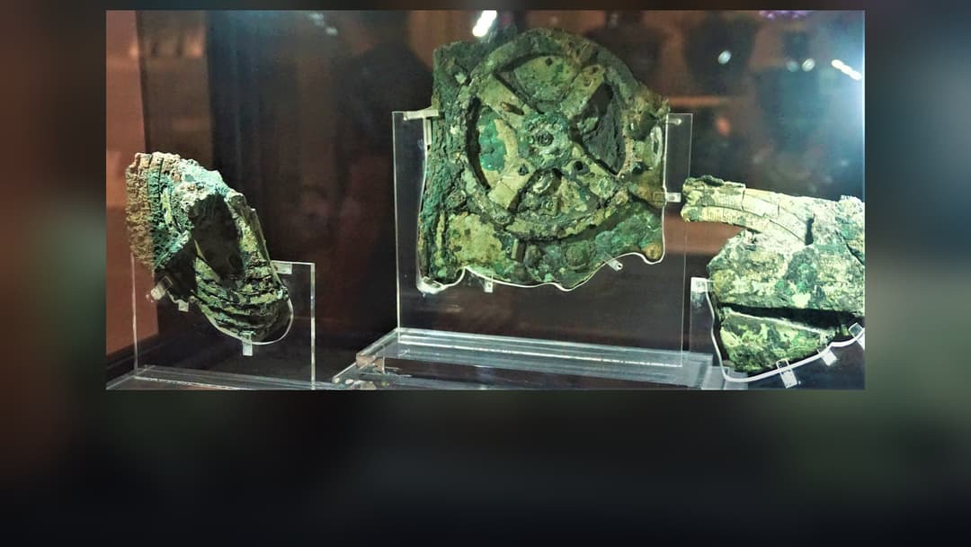 Corroded bronze gear fragment of the Antikythera Mechanism on display in Athens.