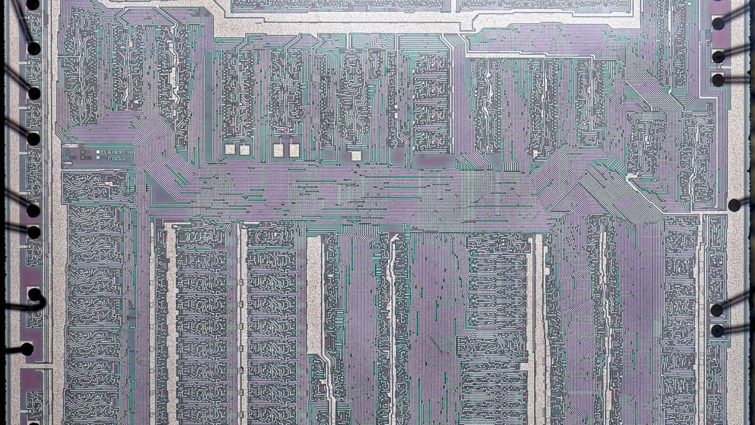 Microscopic top-down view of an integrated circuit silicon die revealing billions of microscopic circuits.