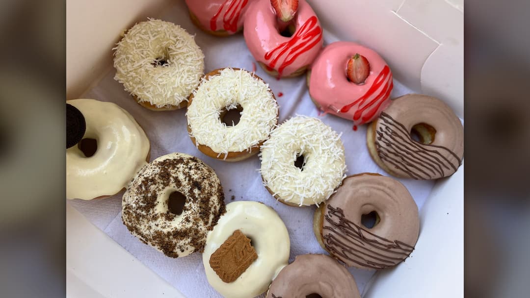 Glazed ring doughnuts on display tray