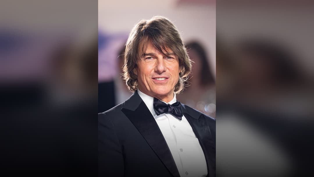 Tom Cruise posing on the red carpet.