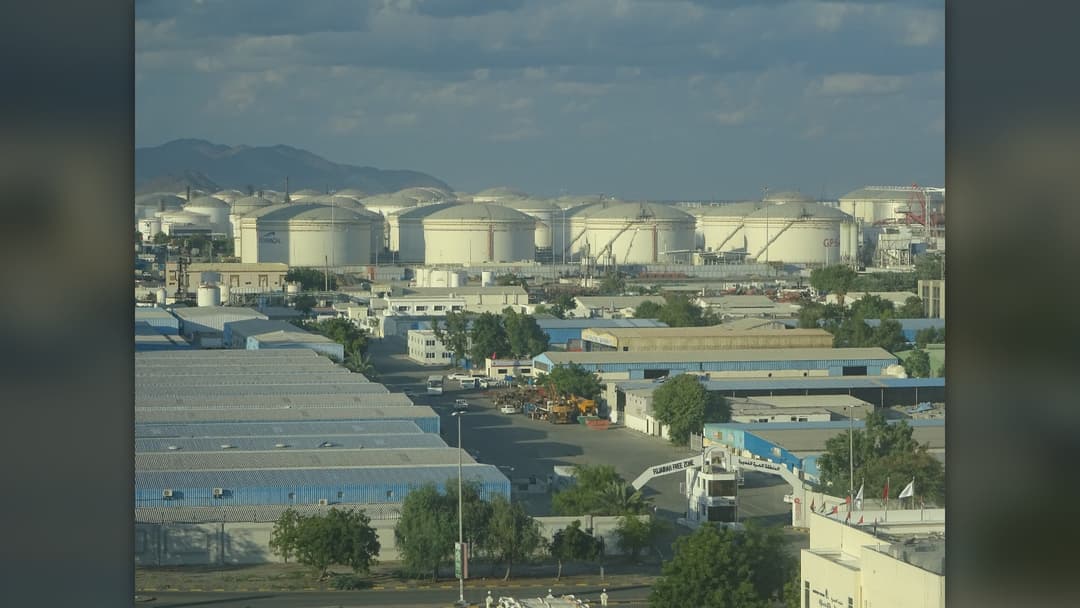 Rows of cylindrical white oil storage tanks at the Port of Fujairah on the Gulf of Oman in the United Arab Emirates.