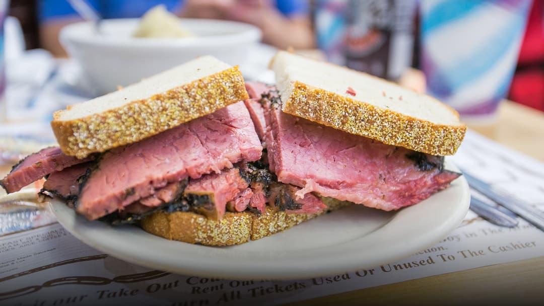 A towering pastrami on rye sandwich stacked high with hand-carved beef brisket at Katz's Delicatessen in New York.