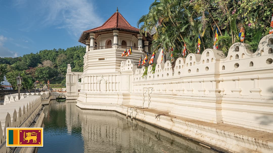 Temple of the Sacred Tooth Relic on Kandy Lake in Sri Lanka with the Sri Lankan flag in the bottom left corner