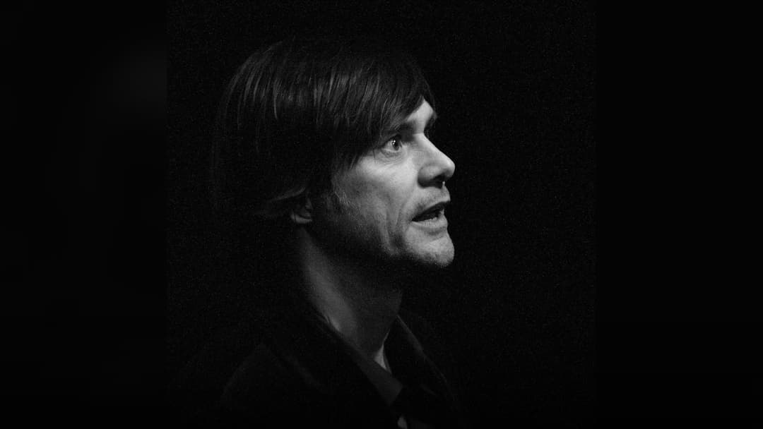 Jim Carrey posing at a film festival premiere.