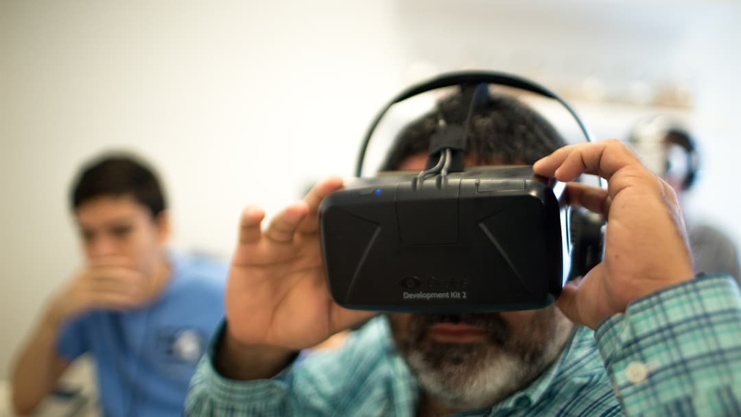 Developer testing an immersive virtual reality headset in a media laboratory