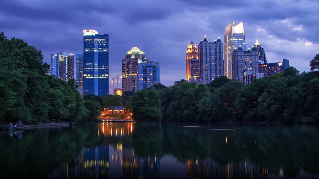 Atlanta Georgia skyline viewed across the lake in Piedmont Park on a clear day.