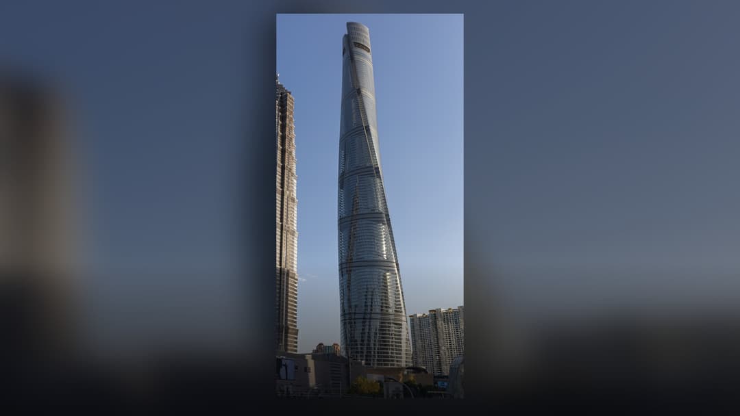 Shanghai Tower's twisting glass cylindrical superstructure rising above Pudong.