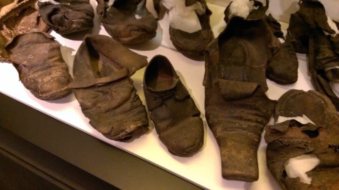 Collection of antique leather concealed shoes found in historic buildings