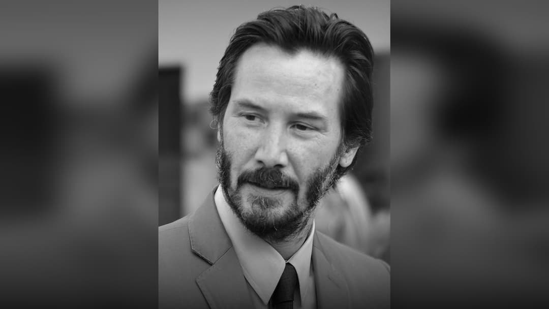 Keanu Reeves posing at a film festival.