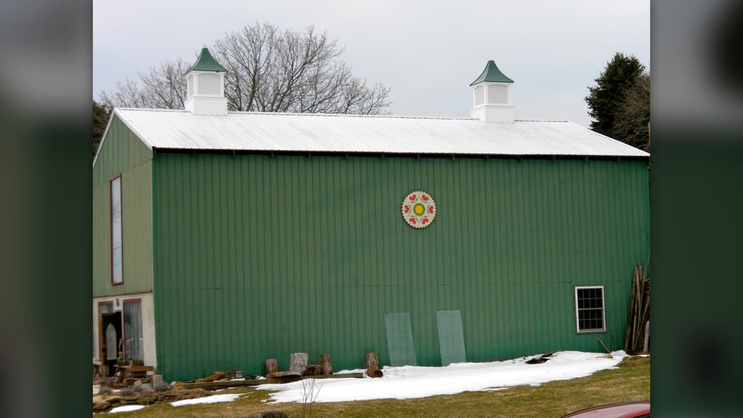 Traditional wooden barn decorated with a painted hex sign star