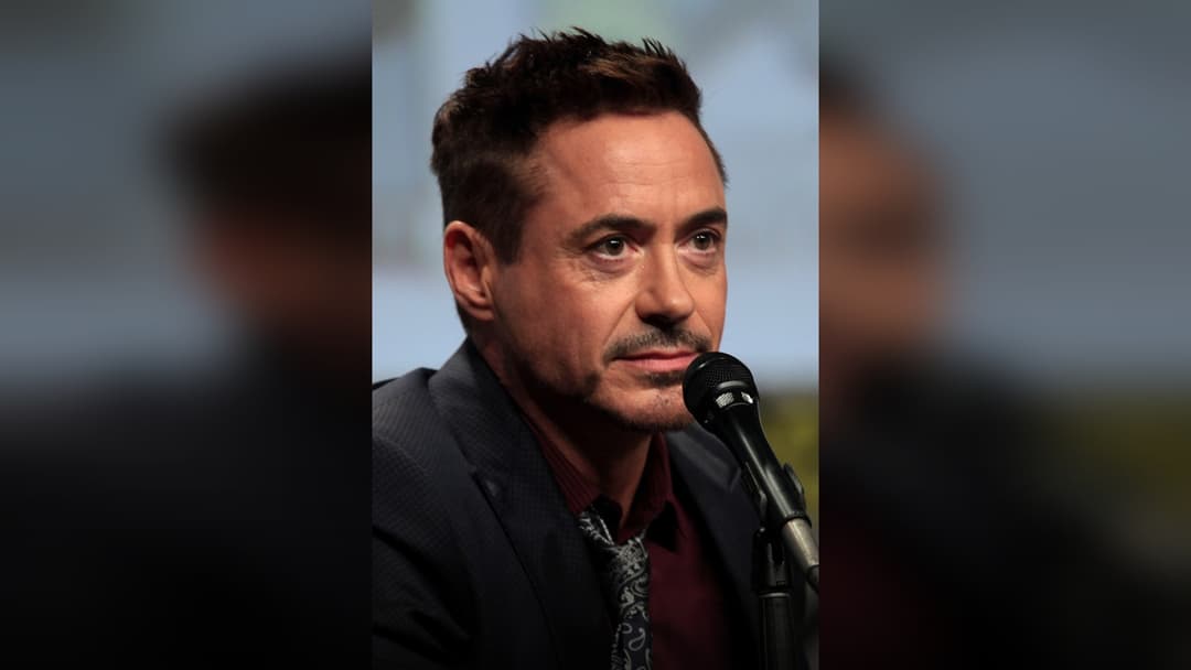 Robert Downey Jr. on stage at an event.