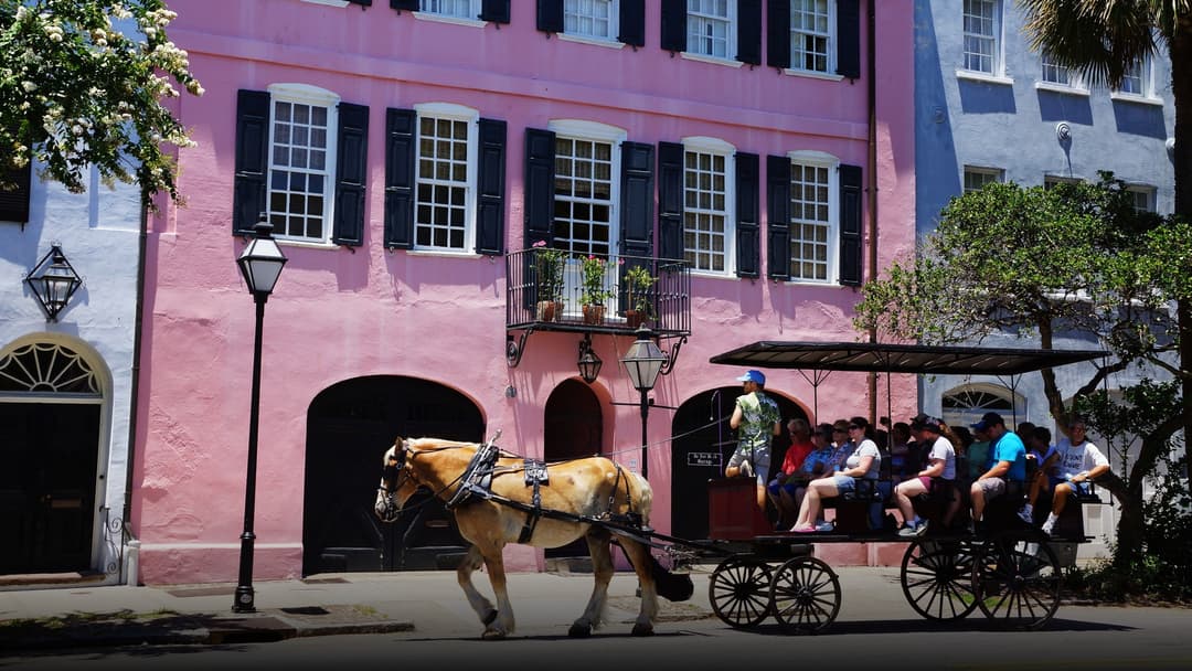 Historic pastel homes and palm trees along the famous Battery waterfront in Charleston South Carolina.