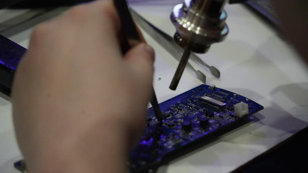 Delicate scientific and technical precision handling demonstrated during an exhibition.