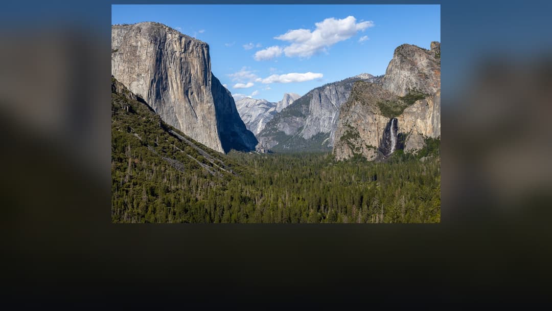 Panoramic landscape vista of Yosemite National Park showing natural geological formations, terrain, and wilderness.