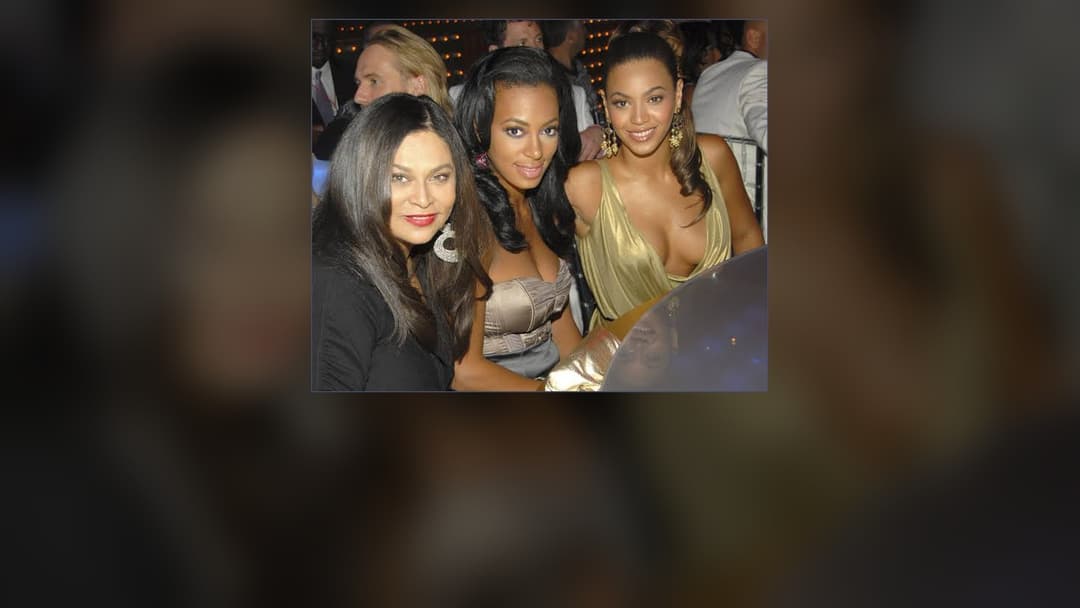 Tina Knowles posing elegantly alongside daughter Beyoncé at a fashion gala.